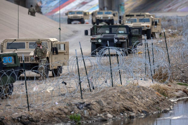 Texas National Guard soldiers stand guard at the U.S.-Mexico border on Jan. 7, 2023, as viewed from Ciudad Juárez, Mexico. 