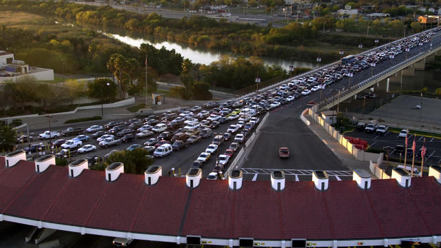 Looking for hidden weapons and ammunitions, Border Patrol (green) and Homeland Security (blue) agents inspect a southbound vehicle on the Lincoln-Juarez Bridge separating the U.S. from Mexico, during an unannounced check-point, in Laredo, June 16 2009. 