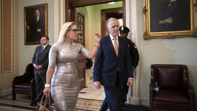 Sens. Kyrsten Sinema and Sen. Thom Tillis leave the Senate chamber on Tuesday, Feb. 25, 2020. 