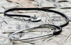Stethscope on pile of US banknotes 