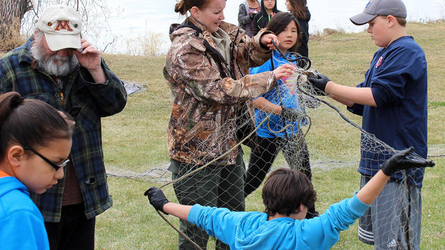 Young students who are members of the Bois Forte Band of Chippewa living near Lake Vermilion learn about fish netting as part of their education that focuses on the band's 1854 treaty with the federal government. 
