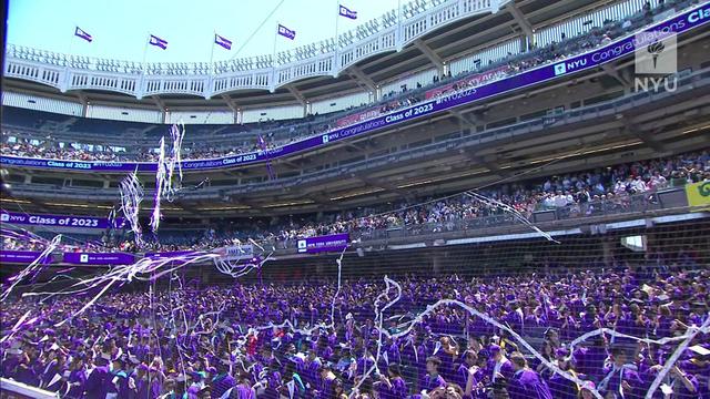 Thousands of people fill seats at Yankee Stadium for New York University's commencement. 