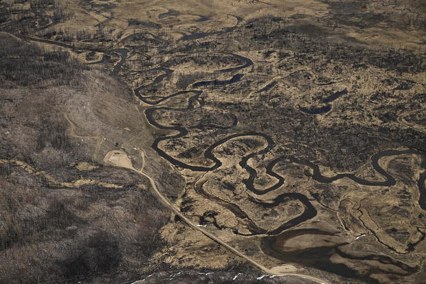 A twisted Colorado River snakes across Kawuneeche Valley scarred by a fire near the headwaters of the Colorado River on May 13, 2023, in Rocky Mountain National Park, Colorado. 
