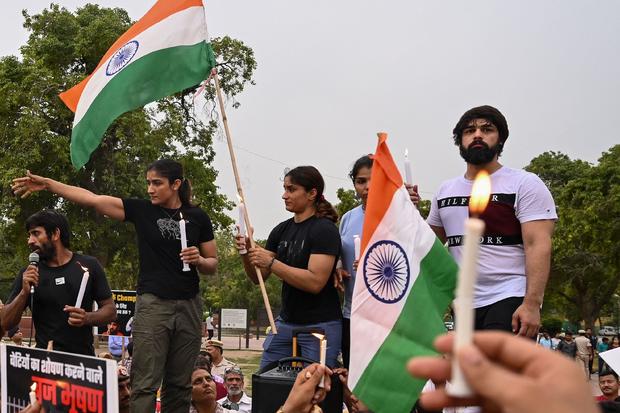 Indian wrestlers take part in a candlelight vigil to protest against the sport's local federation chief over allegations of sexual harassment and intimidation, in New Delhi on May 23, 2023. 