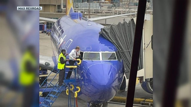 southwest-pilot-climbs-into-plane.jpg 