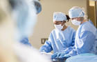 Surgeons preparing for procedure in operating room 