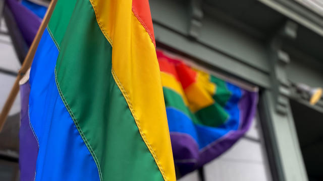 rainbow flag & rainbow flag banner on commercial building front 