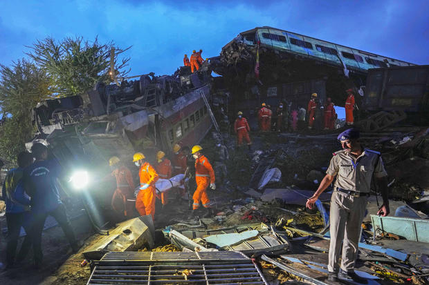 Rescuers carry the body of a victim at the site of passenger trains that derailed in Balasore district, in the eastern Indian state of Orissa, June 3, 2023. 