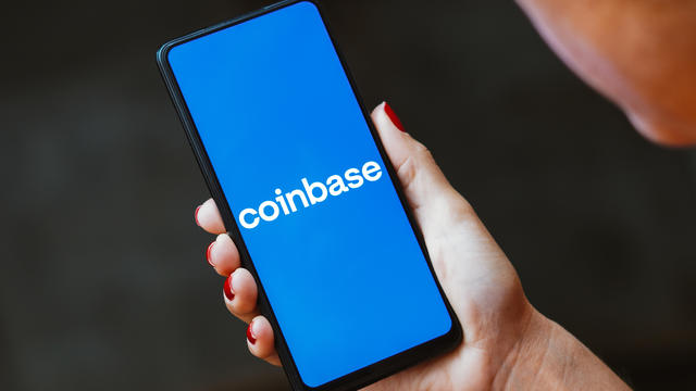 In this photo illustration, the Coinbase logo is displayed 
