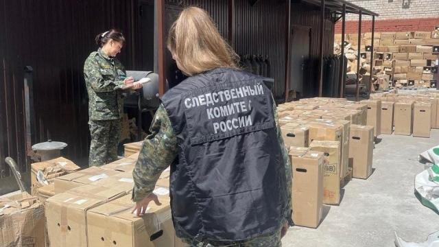Investigators work at a factory where the alcohol-containing drink called "Mister Cider" was produced, in Samara 
