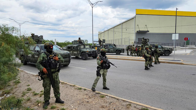 Soldiers guard a crime scene where five men were killed following a chase, in Nuevo Laredo 
