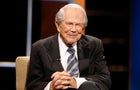 The Rev. Pat Robertson poses a question to a Republican presidential candidate during a forum at Regent University in Virginia Beach, Va., Oct. 23, 2015. 