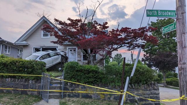 A sedan crashed into the front of a home. 