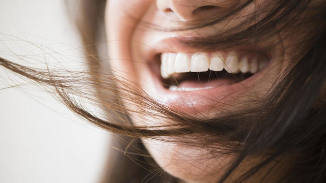 Close up of laughing woman with messy hair 