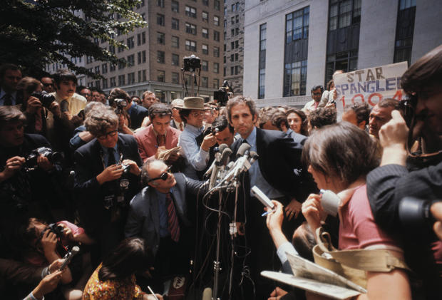 Daniel Ellsberg appears before microphones, surrounded by reporters at the federal building in Boston, June 28, 1971, after surrendering to federal authorities. 