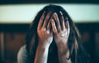 Woman with her head in her hands 