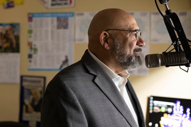 Radio station owner Joe Armstrong stands at a microphone
