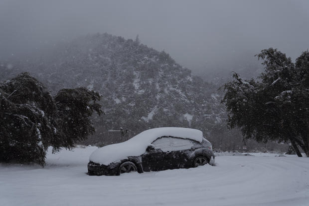 A car covered in snow during a storm in Mount Baldy, California, US, on Friday, Feb. 24, 2023. 