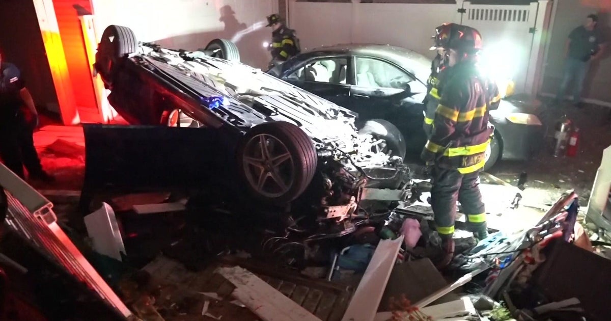 Driver, passenger hospitalized after car slams into 2 homes, overturns ...