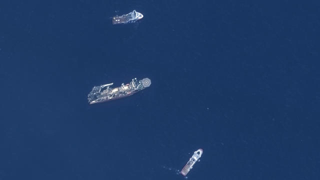 In this satellite image provided by Maxar Technologies, from top to bottom, the vessels Horizon Arctic, Deep Energy and Skandi Vinland search for the missing submersible Titan, Thursday, June 22, 2023, in the Atlantic Ocean. 