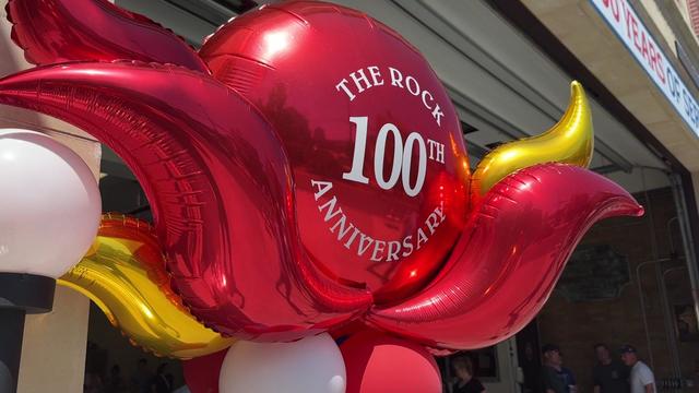 A red balloon with the words "The Rock 100th Anniversary" printed on it. 