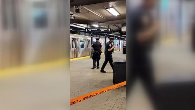 A subway platform is blocked off by crime scene tape. 