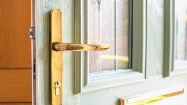 Shallow focus of an ornate, high security door handle and lock seen on a newly installed composite double glazed door 