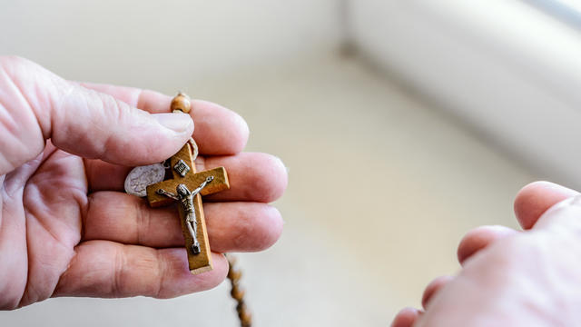 The Divine Mercy Rosary in woman hands 