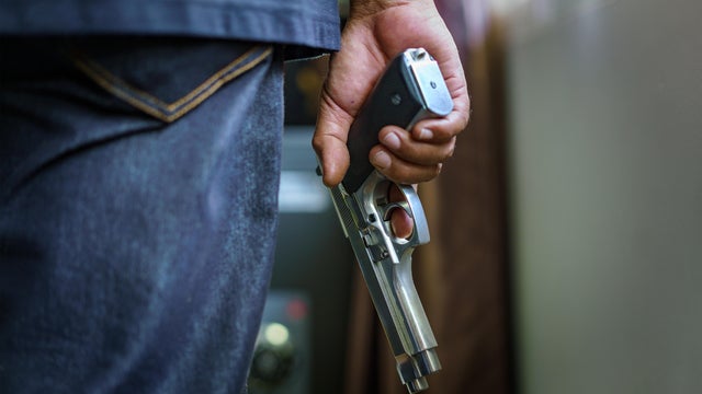 Man carrying a gun to rob the money.