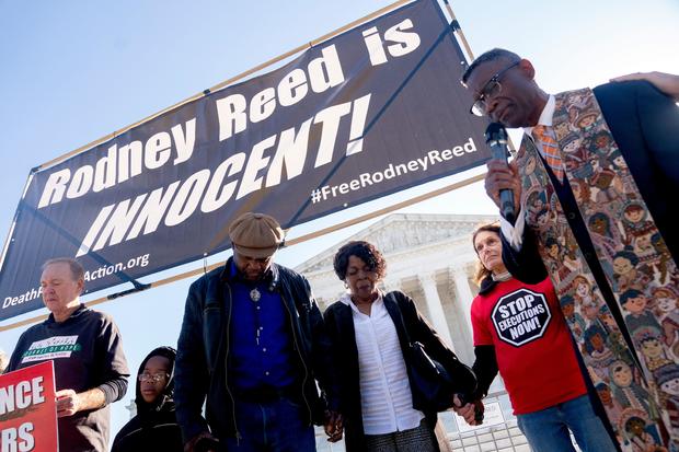 Roderick Reed, brother of Rodney Reed, and Sandra Reed, mother of Rodney Reed, pray with supporters outside the US Supreme Court in Washington, DC, on October 11, 2022. 