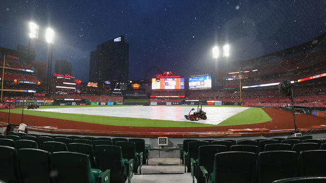 A tarp covers the infield at Busch Stadium during a rain delay for the game between the St. Louis Cardinals and the New York Yankees on June 30, 2023 in St Louis, Missouri. 