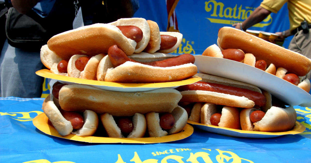 What does a hot dog eating contest do to your stomach? Experts detail the health effects of competitive eating.