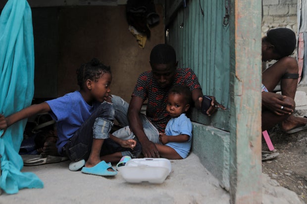 Children have a meal at at camp for displaced persons in Haiti 