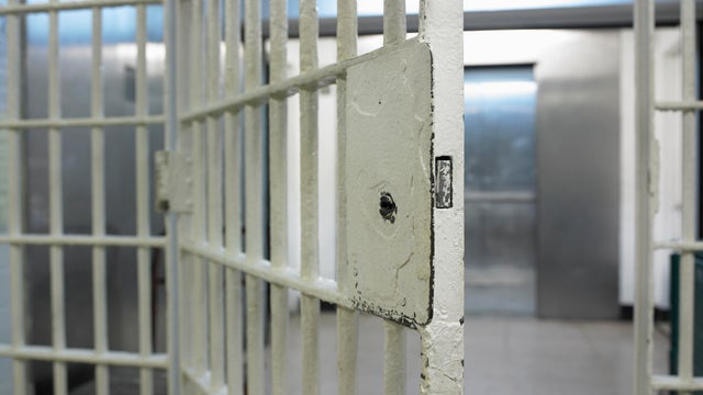 Open door to prison cell 