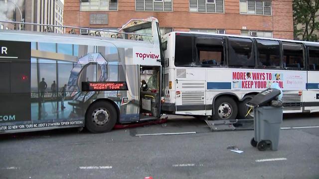 A sightseeing bus sits crashed into the back of an MTA bus. 