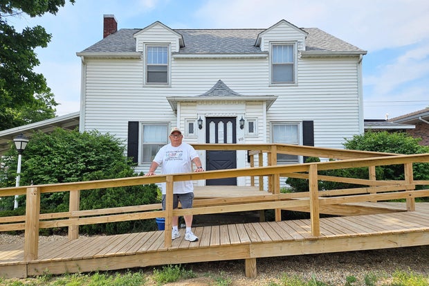Todd Noack stands in front of Rhonda's House, a respite site for mental health care in Iowa