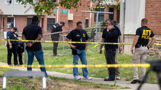 Authorities search for evidence at the scene of last nights mass shooting that left 2 dead and 20 wounded, on July 02 in Baltimore, MD. 