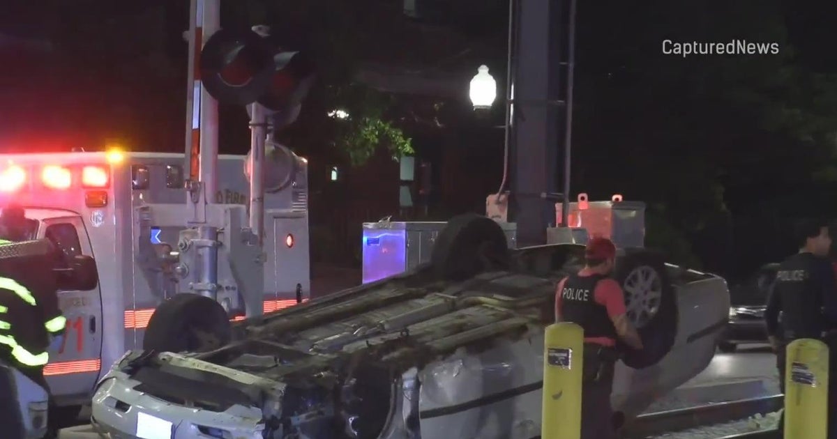 Car hits pole, flips over on Metra tracks in South Shore - CBS Chicago