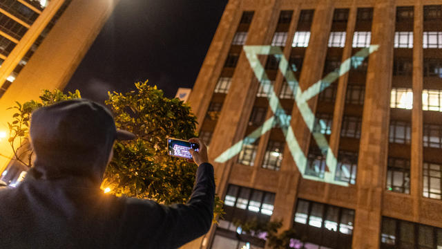 Twitter's new logo is seen projected on the corporate headquarters building in downtown San Francisco, California 