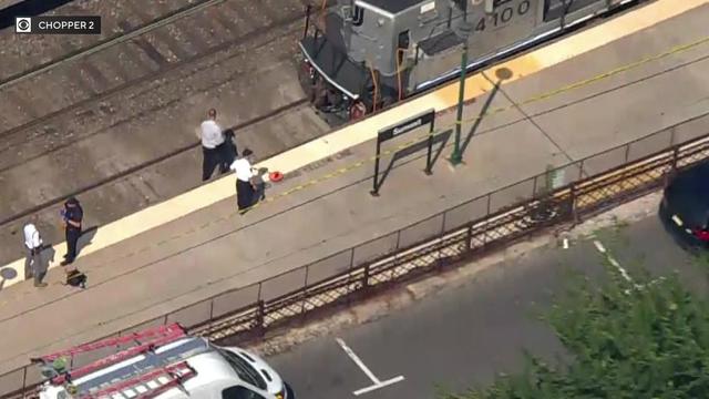 An aerial view of the platform at the NJ Transit Summit station. Crime scene tape blocks off part of the platform as a train sits at the station. 