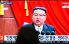 A TV screen shows footage of  North Korean leader Kim Jong- 