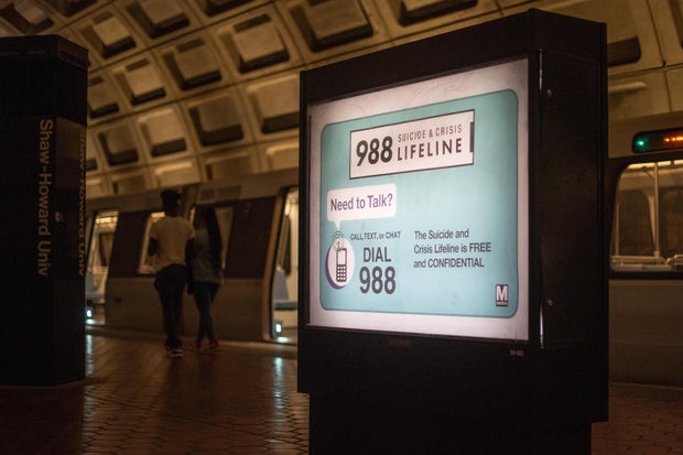 An ad for the 988 Suicide and Crisis Lifeline is seen in the Washington, D.C. Metro