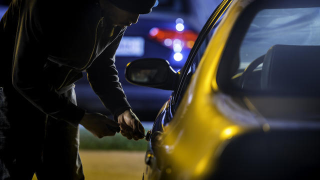 Car Thief Using a Screwdriver to Brake into a Car 