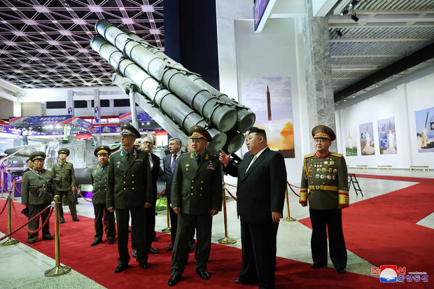 North Korean leader Kim Jong Un and Russia's Defense Minister Sergei Shoigu visit an exhibition of armed equipment 