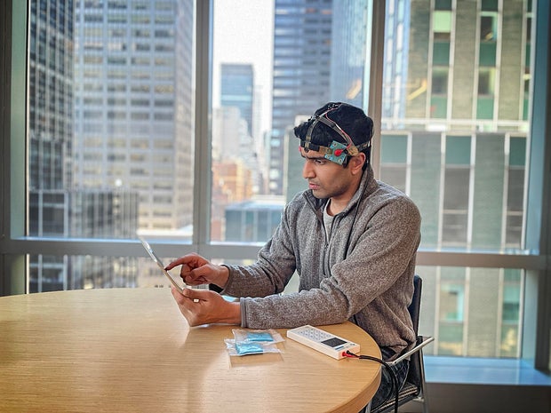Man wearing a transcranial direct current simulation device on his head