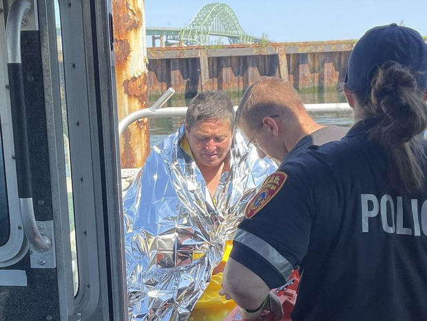 First responders help Dan Ho, 63, after he was rescued from the Atlantic Ocean off the coast of New York, July 31, 2023. 