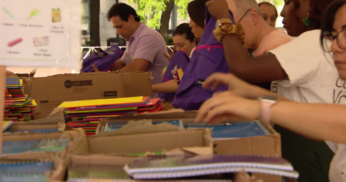 Volunteers pack thousands of backpacks with school supplies for lowincome students Volunteers pack thousands of backpacks with school supplies for lowincome students