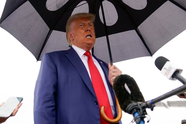 Former President Donald Trump speaks before he boards his plane at Ronald Reagan Washington National Airport on Thursday, Aug. 3, 2023, in Arlington, Virginia.