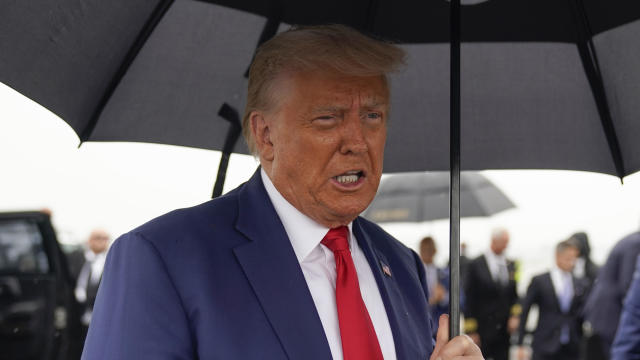 Former President Donald Trump speaks before he boards his plane at Ronald Reagan Washington National Airport, Thursday, Aug. 3, 2023, in Arlington, Virginia. 