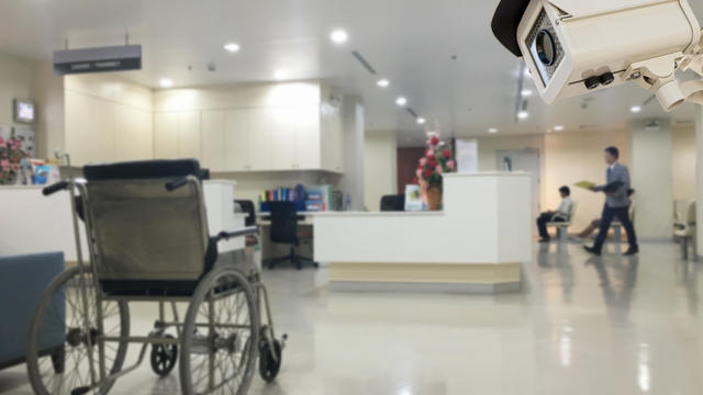 The CCTV security camera operating in office hospital blur background. 